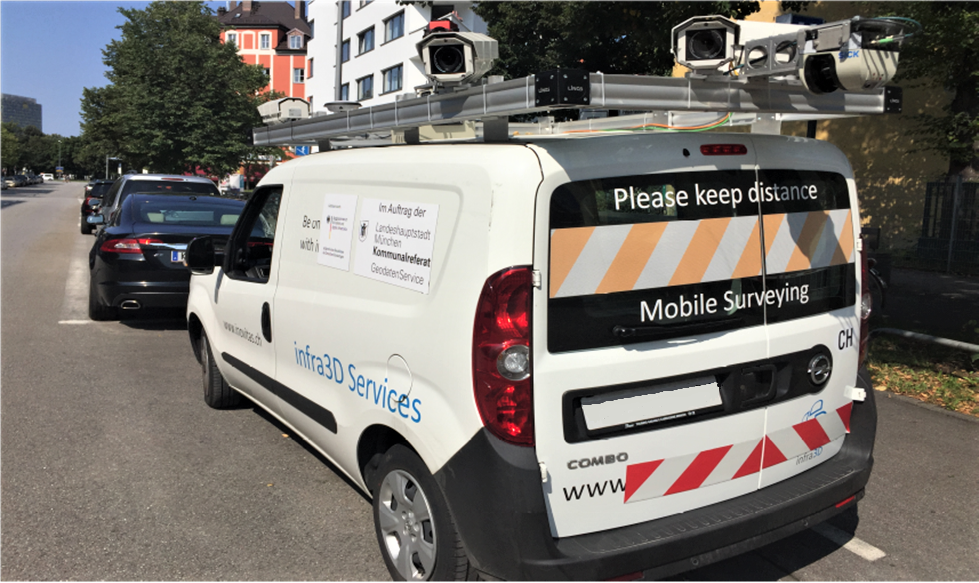 A surveying vehicle from iNovitas equipped with camera setup. On the rear window, it reads 'Please keep distance Mobile Mapping', while on the side of the vehicle, 'infra3D Services' is displayed along with a sticker stating 'on behalf of the City of Munich, Department of Communal Services GeodataService'.